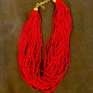 Red multi strand beaded necklace